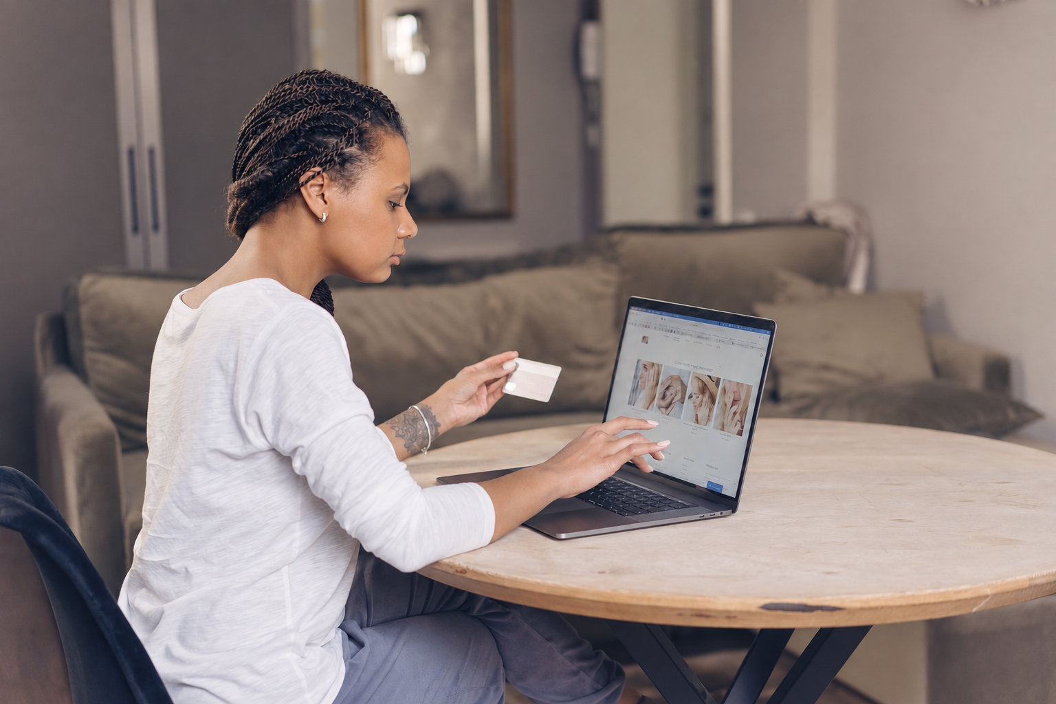 Customer shopping online with a payment card and laptop
